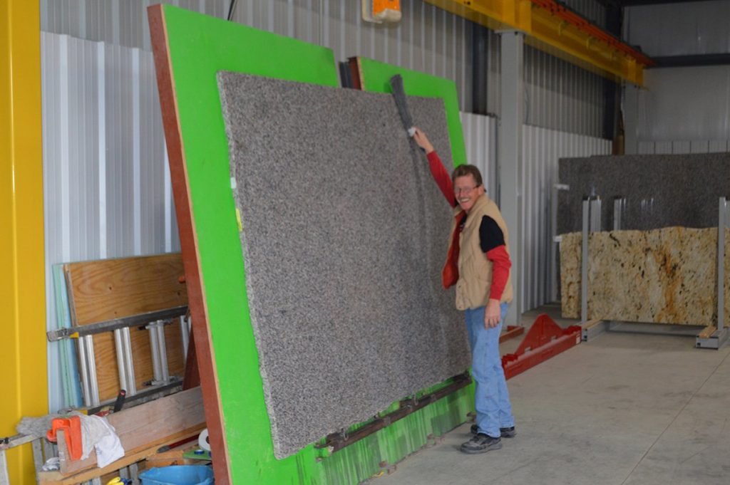 man working with granite
