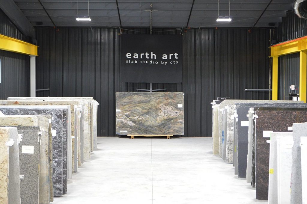 slabs of granite under banner for "earth art slab studio by cts"