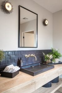 Beautiful black washplane sink on a wooden counter.